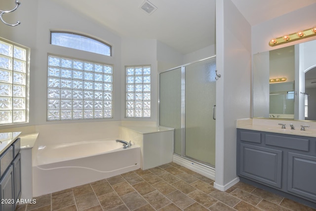 bathroom with vanity and separate shower and tub