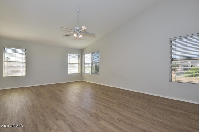 empty room featuring high vaulted ceiling, dark hardwood / wood-style floors, and ceiling fan