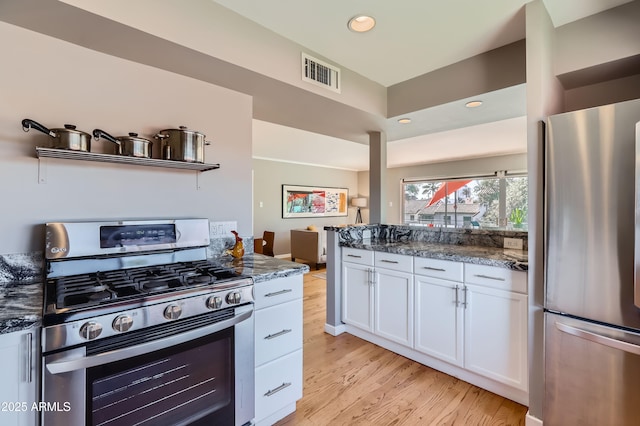 kitchen with visible vents, white cabinetry, recessed lighting, stainless steel appliances, and light wood-style floors