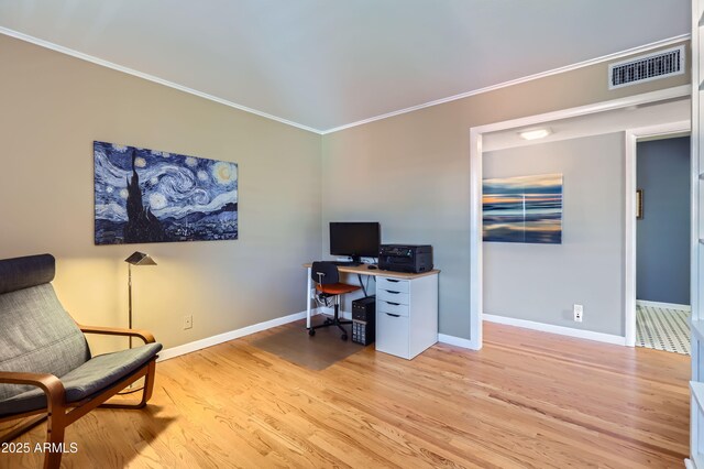 office with visible vents, light wood-style flooring, baseboards, and ornamental molding