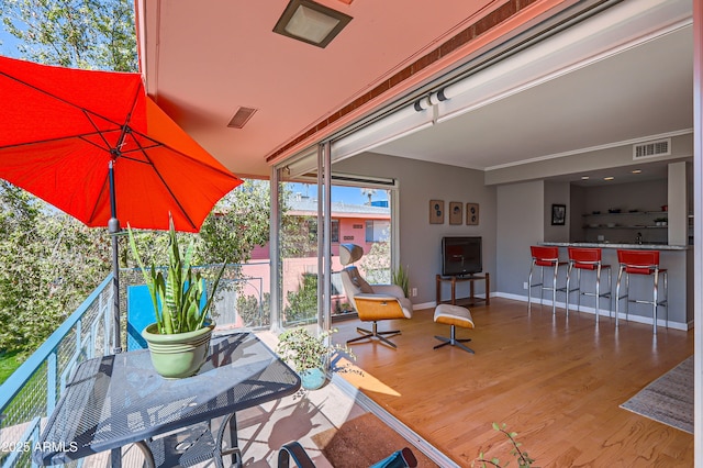 deck featuring visible vents and outdoor dry bar