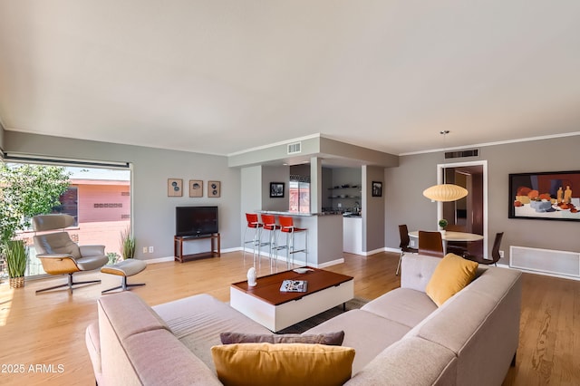 living room featuring light wood-type flooring and visible vents