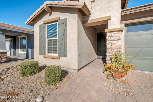 entrance to property featuring a garage