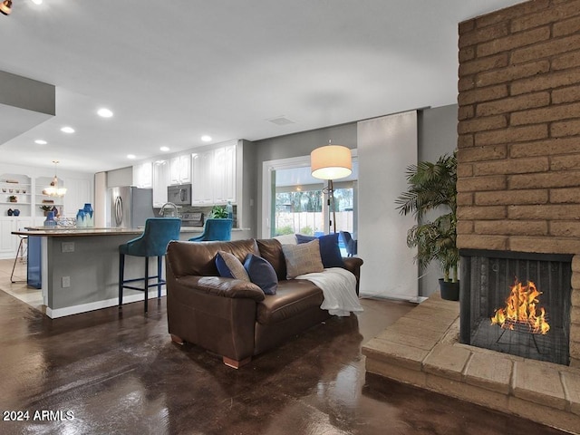 living room with a brick fireplace and built in features