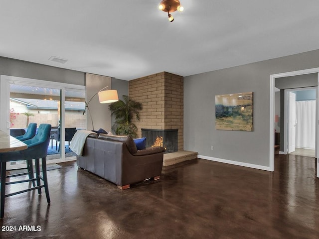 living room with a brick fireplace