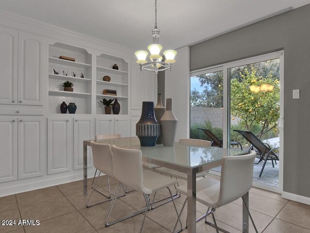 tiled dining room featuring built in shelves and a notable chandelier