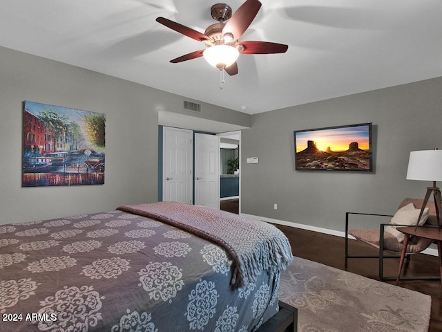 bedroom with ceiling fan and a closet