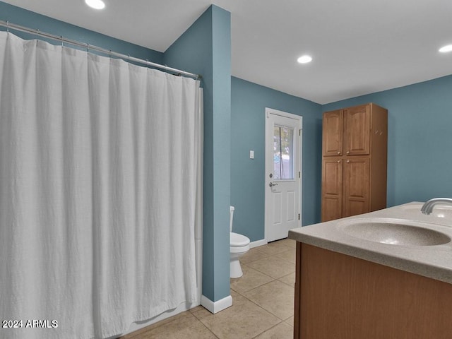 bathroom with tile patterned flooring, vanity, and toilet