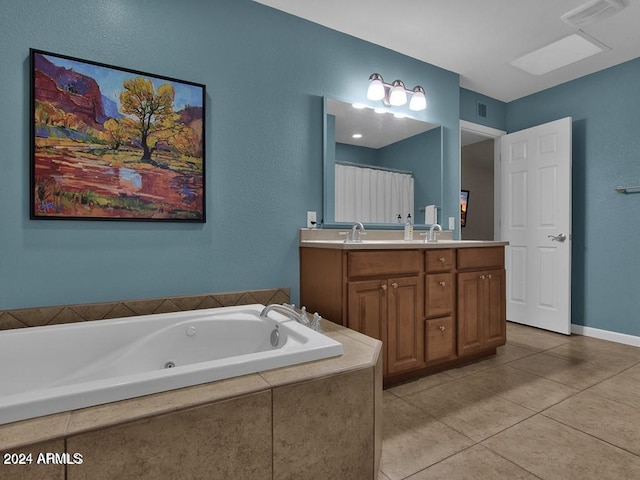 bathroom with vanity, tile patterned floors, and tiled tub