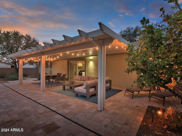 patio terrace at dusk with an outdoor living space and a pergola