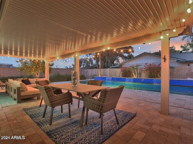 patio terrace at dusk featuring outdoor lounge area