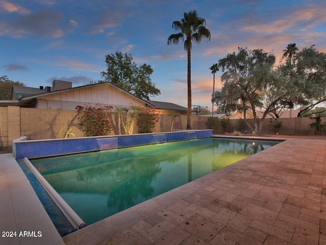 view of pool at dusk