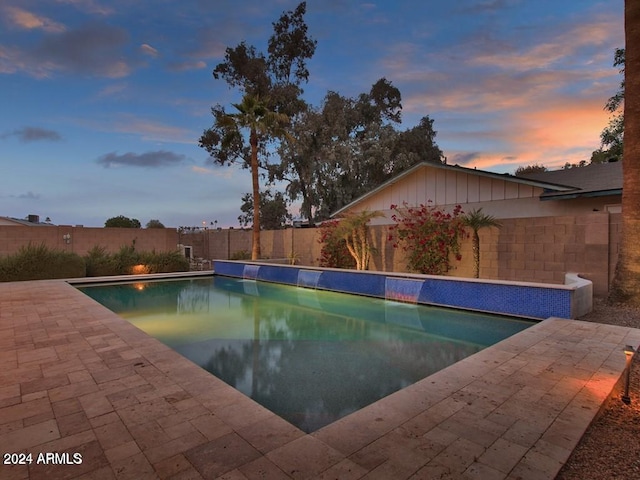 view of pool at dusk