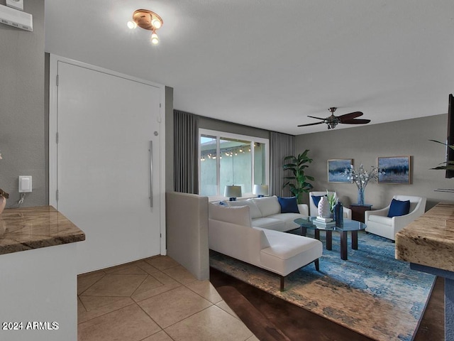 tiled living room with ceiling fan