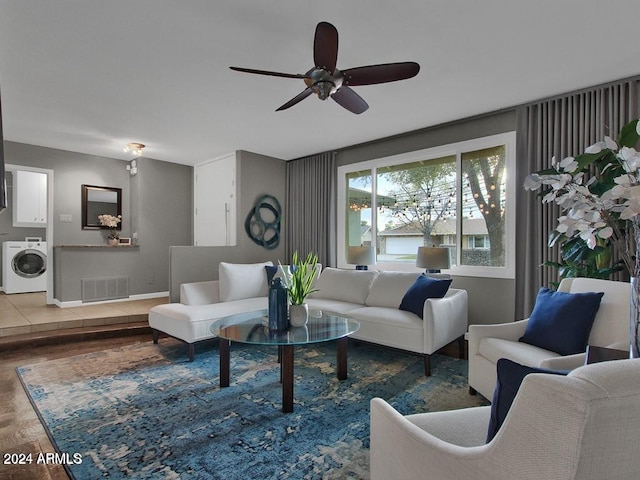 living room featuring washer / dryer, ceiling fan, and hardwood / wood-style floors