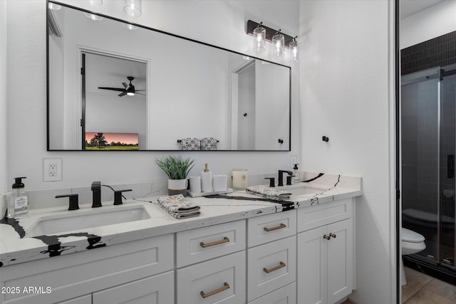 16533 E Dale Ln, Scottsdale, AZ 85262 - full bath featuring double vanity, a shower stall, ceiling fan, and toilet