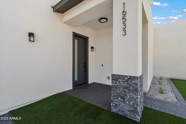16533 E Dale Ln, Scottsdale, AZ 85262 - doorway to property featuring stucco siding and stone siding
