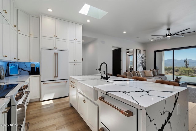 16533 E Dale Ln, Scottsdale, AZ 85262 - kitchen with white appliances, a sink, light wood-style flooring, white cabinets, and recessed lighting