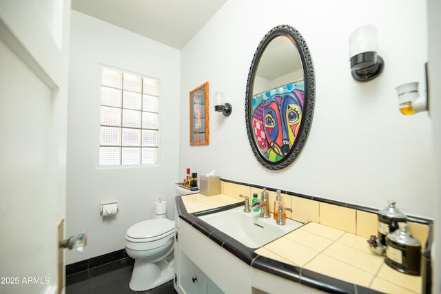 1441 E Hubbell St, Phoenix, AZ 85006 - bathroom featuring vanity, tile patterned flooring, and backsplash