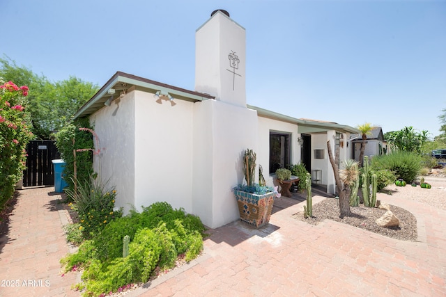 1441 E Hubbell St, Phoenix, AZ 85006 - view of home's exterior with stucco siding and a chimney