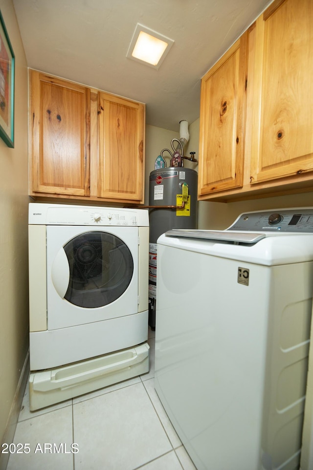 1441 E Hubbell St, Phoenix, AZ 85006 - laundry room featuring independent washer and dryer, cabinet space, light tile patterned floors, and water heater