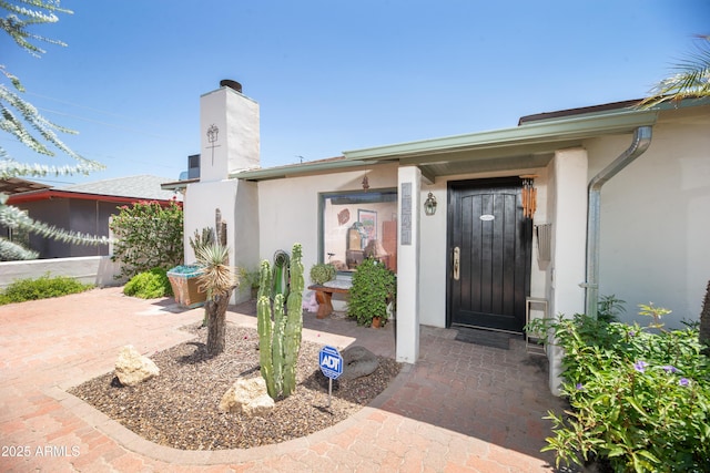 1441 E Hubbell St, Phoenix, AZ 85006 - doorway to property featuring stucco siding and a chimney