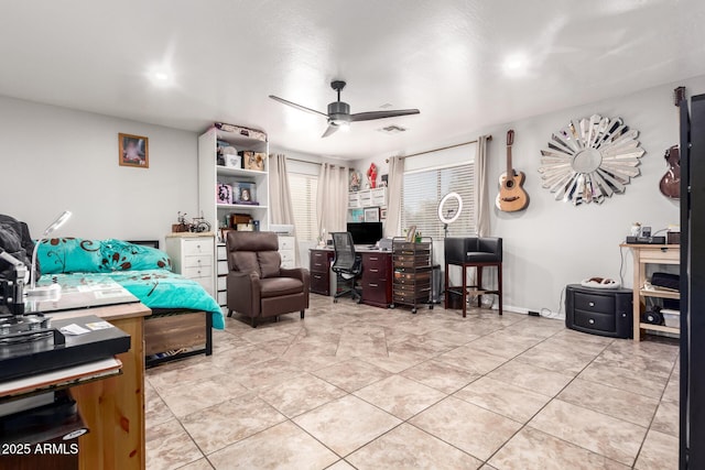 office space featuring visible vents, light tile patterned floors, a ceiling fan, and baseboards