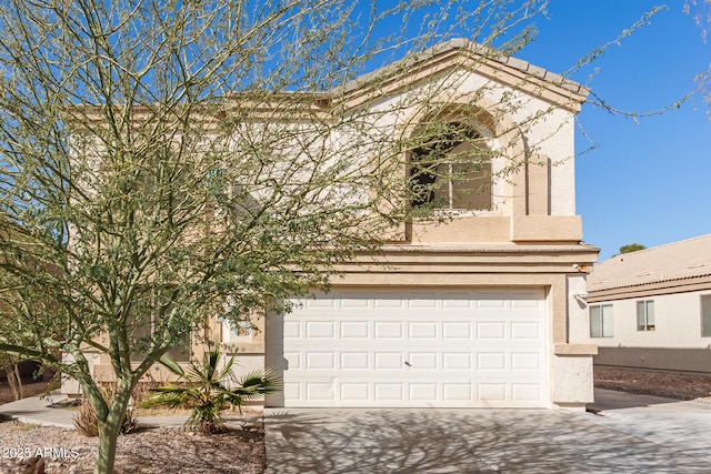 view of front of property with a garage, driveway, and stucco siding