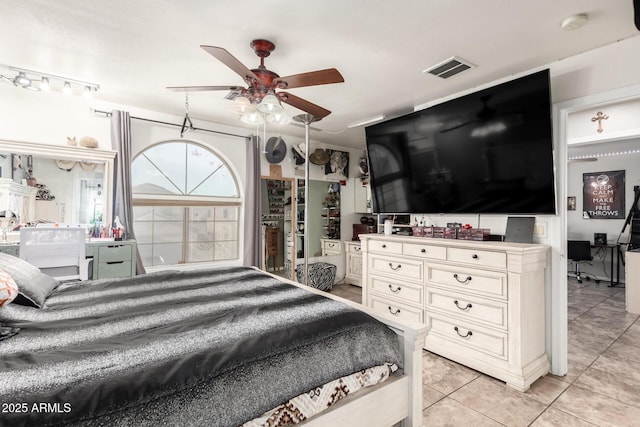 bedroom with light tile patterned floors, visible vents, and a ceiling fan