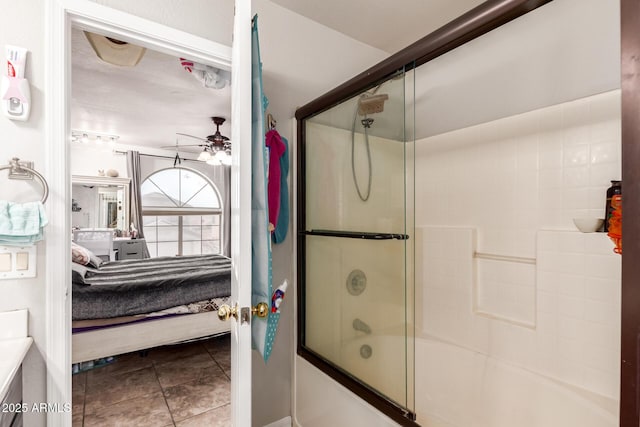 full bathroom featuring ceiling fan, shower / bath combination with glass door, ensuite bath, and tile patterned floors