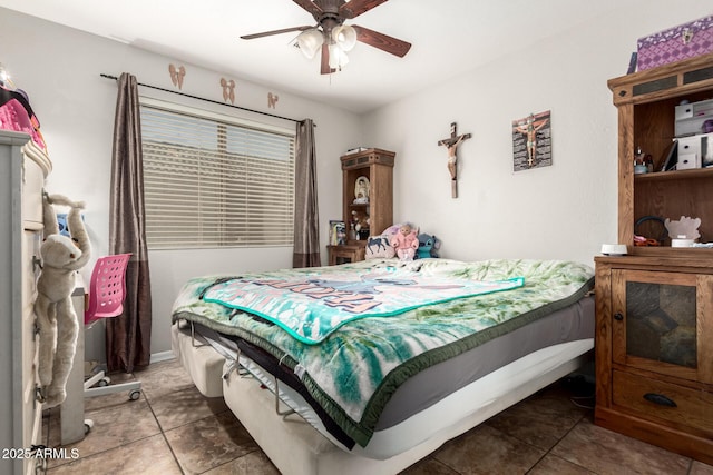 bedroom with dark tile patterned flooring and ceiling fan