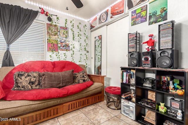 sitting room with a ceiling fan and light tile patterned floors