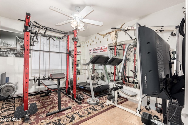 workout area with tile patterned flooring and ceiling fan