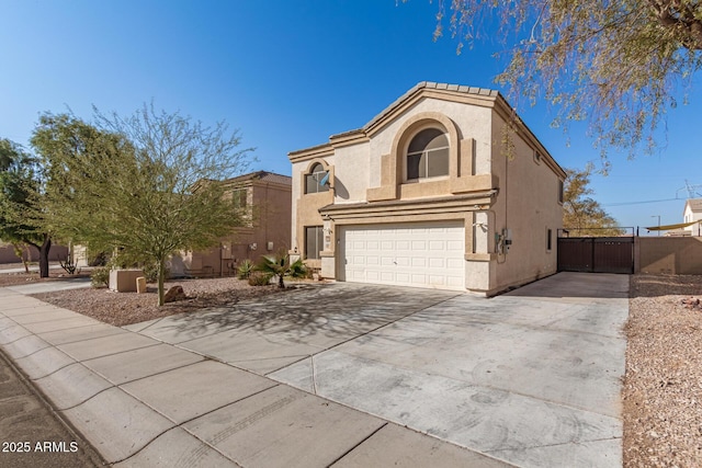 mediterranean / spanish-style house with concrete driveway, fence, an attached garage, and stucco siding