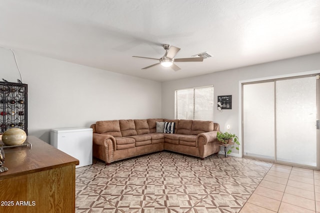 living room with visible vents and a ceiling fan