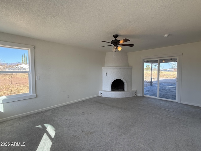 unfurnished living room featuring carpet flooring, a large fireplace, and baseboards