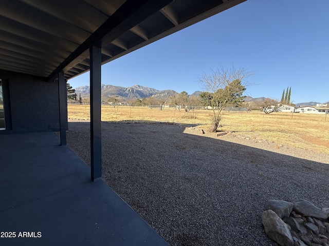 view of yard with a mountain view and a patio