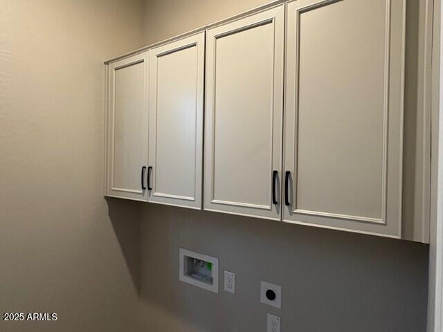 laundry room with hookup for an electric dryer, cabinet space, and washer hookup