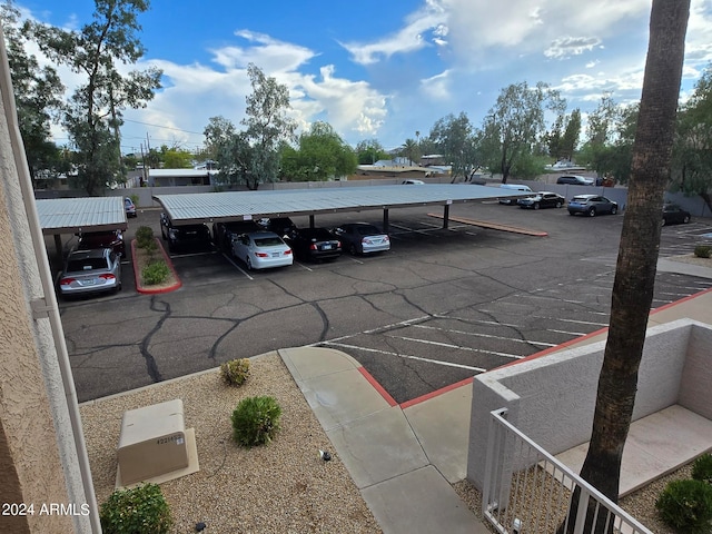 view of parking / parking lot featuring a carport