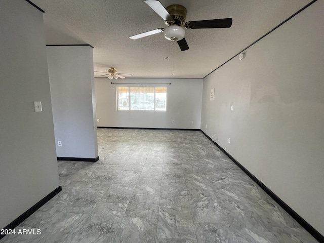 empty room featuring a textured ceiling and ceiling fan