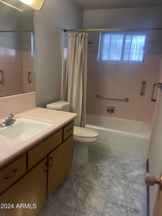 full bathroom with vanity, shower / bath combination with curtain, and toilet