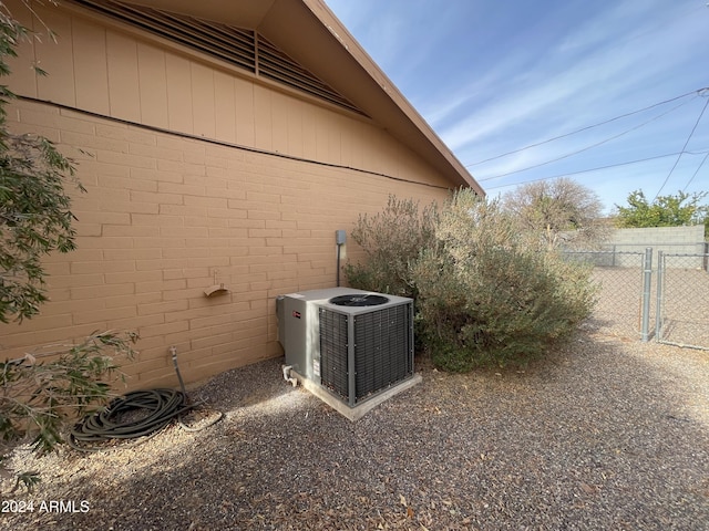 view of side of home with central AC