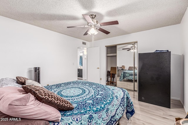 421 S 113th Way, Mesa, AZ 85208 - bedroom featuring a closet, wood finished floors, a textured ceiling, and ceiling fan