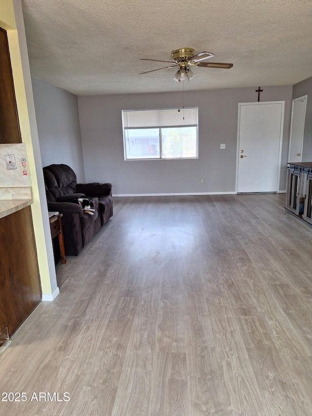 421 S 113th Way, Mesa, AZ 85208 - living room featuring wood finished floors, ceiling fan, a textured ceiling, and baseboards