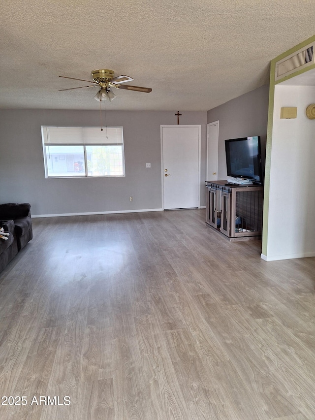 421 S 113th Way, Mesa, AZ 85208 - unfurnished living room with wood finished floors, a textured ceiling, a ceiling fan, and baseboards
