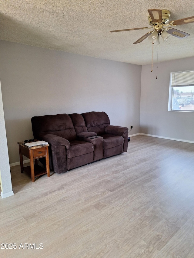 421 S 113th Way, Mesa, AZ 85208 - living room with wood finished floors, ceiling fan, baseboards, and a textured ceiling