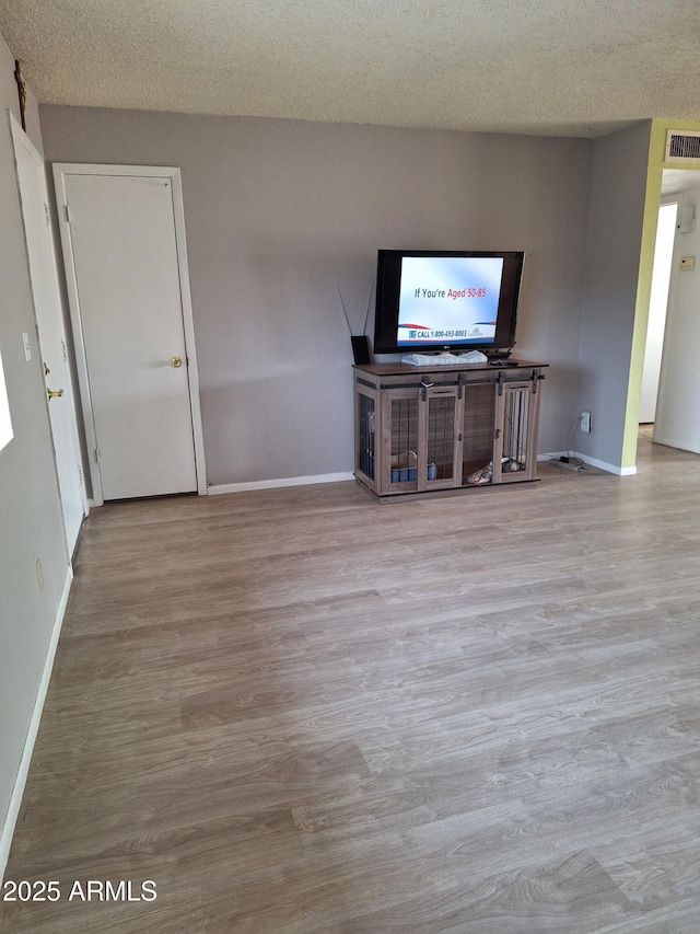 421 S 113th Way, Mesa, AZ 85208 - unfurnished living room featuring baseboards, wood finished floors, and a textured ceiling