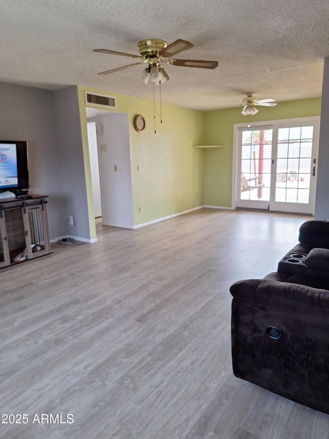 421 S 113th Way, Mesa, AZ 85208 - living area with a textured ceiling, a ceiling fan, wood finished floors, and baseboards