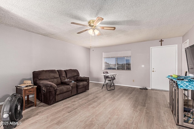 421 S 113th Way, Mesa, AZ 85208 - living area featuring a ceiling fan, light wood finished floors, a textured ceiling, and baseboards