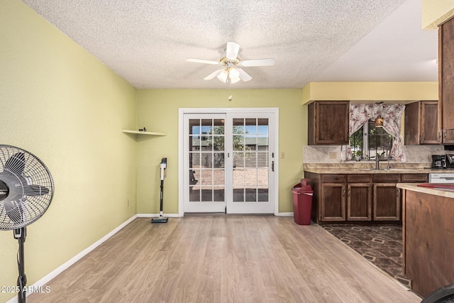421 S 113th Way, Mesa, AZ 85208 - kitchen with wood finished floors, a ceiling fan, light countertops, a textured ceiling, and dark brown cabinetry